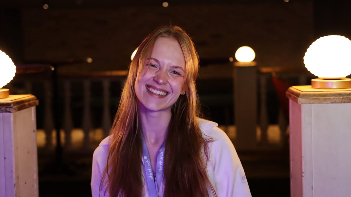 Ema Vaitekūnaitė smiling at a live event, between performances
